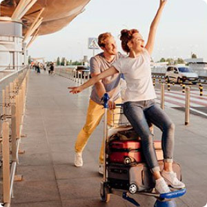 Two people with luggage on a cart